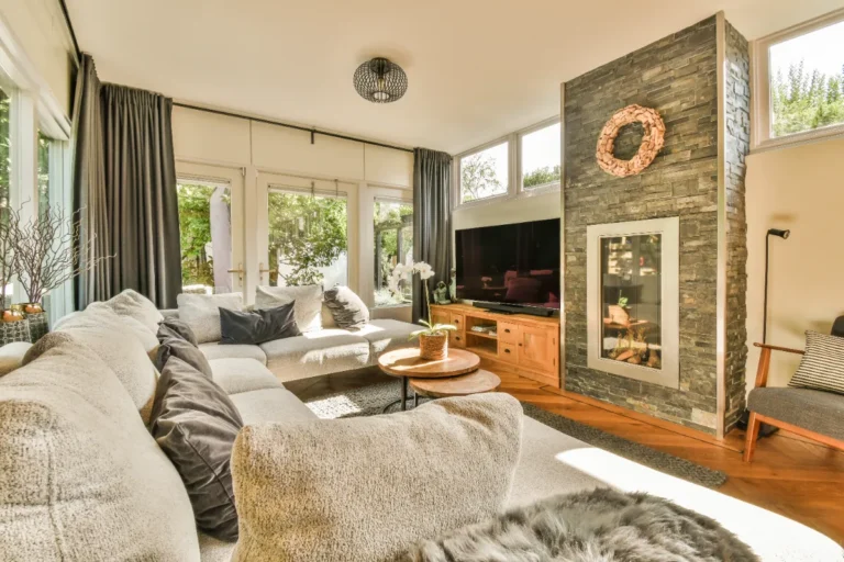 A cozy living room in an apartment with a fireplace.